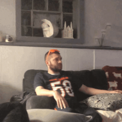 Man Sitting On Couch Wearing 53 Shirt GIF