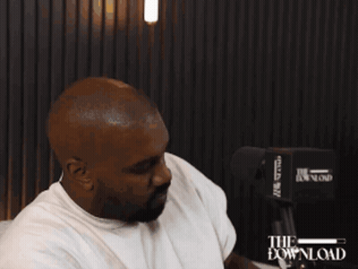 Man Sitting On Couch Wearing Headset Saying The Download GIF