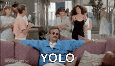 Man Sitting On Couch With Arms Outstretched Surrounded By People GIF