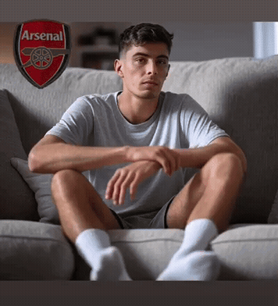 Man Sitting On Couch With Arsenal Logo GIF