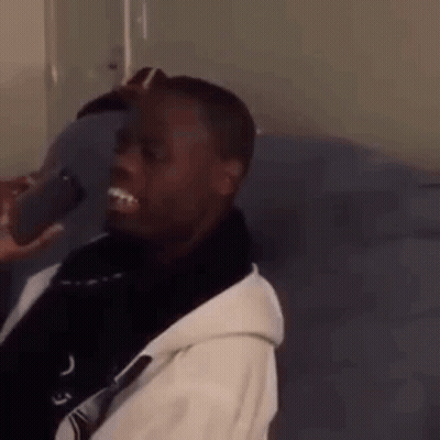 Man Sitting On Couch With Cell Phone GIF