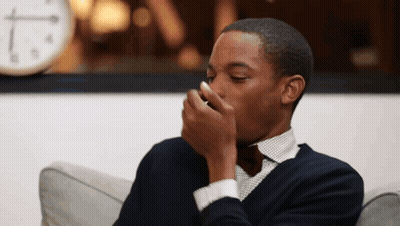 Man Sitting On Couch With Clock Background GIF