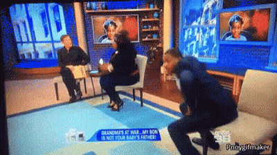 Man Sitting On Couch With Grandma's At War Sign GIF