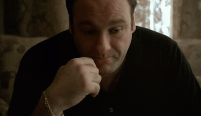 Man Sitting On Couch With Hand On Chin GIF