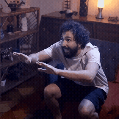 Man Sitting On Couch With Hands Outstretched GIF