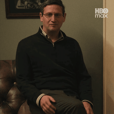 Man Sitting on Couch With HBO Max Logo