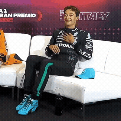 Man Sitting On Couch With Italy Sign GIF