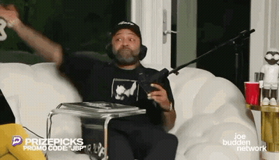 Man Sitting On Couch With Microphone GIF