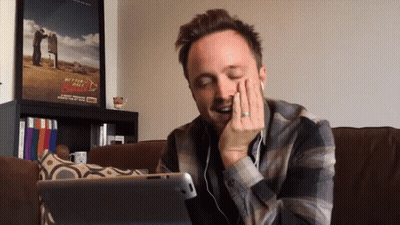 Man Sitting On Couch With Tablet And Better Call Saul Poster GIF