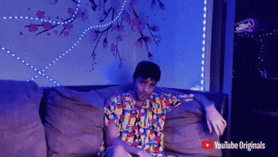 Man Sitting On Couch With YouTube Originals Logo GIF