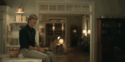 Man Sitting On Counter Looking Out Window GIF