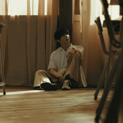 Man Sitting On Floor By Window GIF