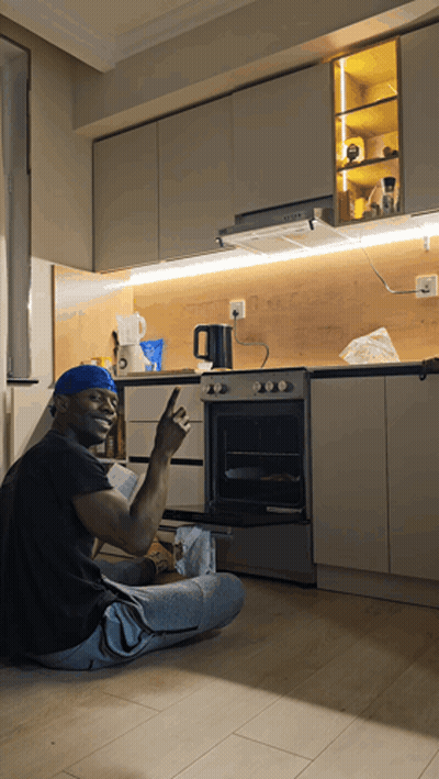 Man Sitting On Floor Giving Peace Sign GIF