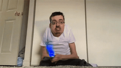 Man Sitting On Floor Holding Blue Light GIF