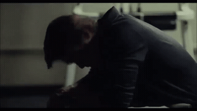 Man Sitting On Floor In Dark Room GIF