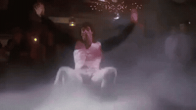 Man Sitting On Floor In Dark Room Surrounded By Smoke GIF