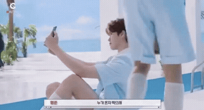 Man Sitting On Floor Taking Selfie GIF