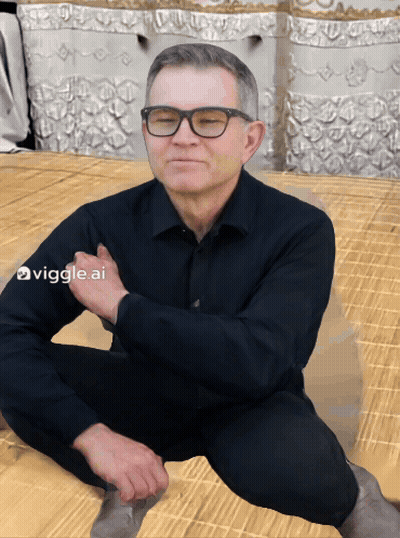 Man Sitting On Floor With Glasses And Black Shirt GIF