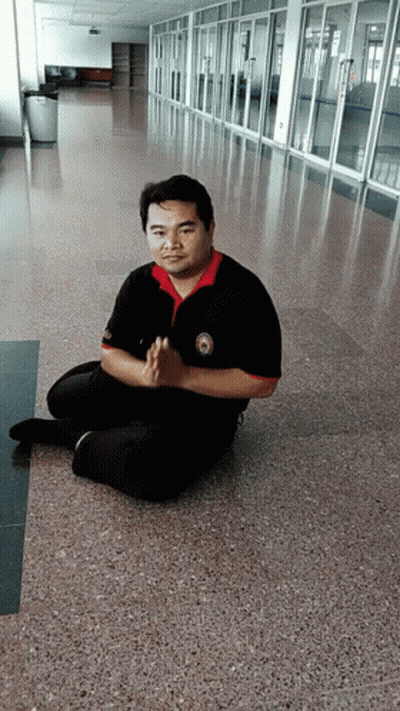 Man Sitting On Floor With Hands Folded GIF