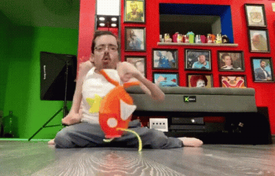 Man Sitting On Floor With Stuffed Animal In Front Of Picture Wall GIF