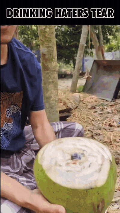 Man Sitting On Ground Holding Coconut With Drinking Haters Tear GIF