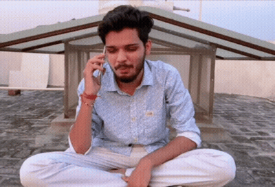 Man Sitting On Ground Talking On Cellphone GIF