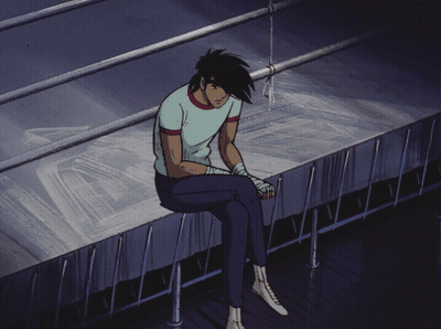 Man Sitting On Ledge With Head Down GIF