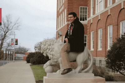 Man Sitting On Lion Statue GIF