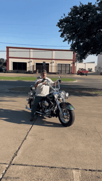 Man Sitting On Motorcycle In Desert With Woman Behind GIF