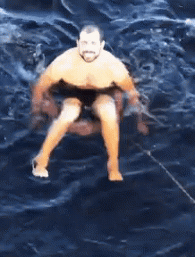 Man Sitting On Raft In Ocean GIF
