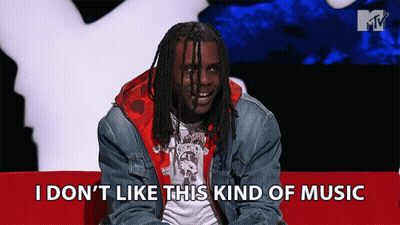 Man Sitting On Red Couch Saying I Don T Like This Music GIF