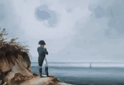 Man Sitting On Rock Near Water GIF