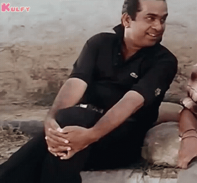 Man Sitting On Rock Smiling GIF