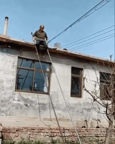 Man Sitting On Roof With Ladder GIF