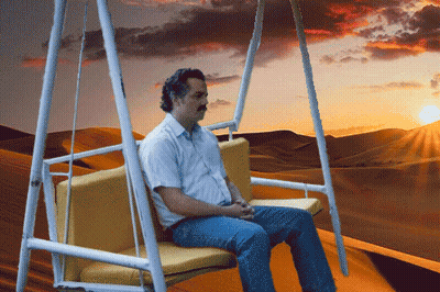 Man Sitting On Swing In Desert GIF