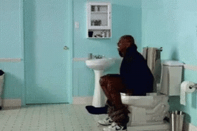 Man Sitting On Toilet In Blue Bathroom GIF