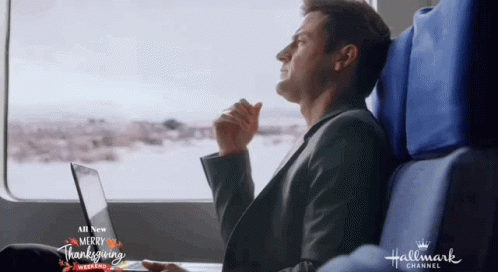 Man Sitting On Train Looking Out Window Hallmark Channel Logo GIF