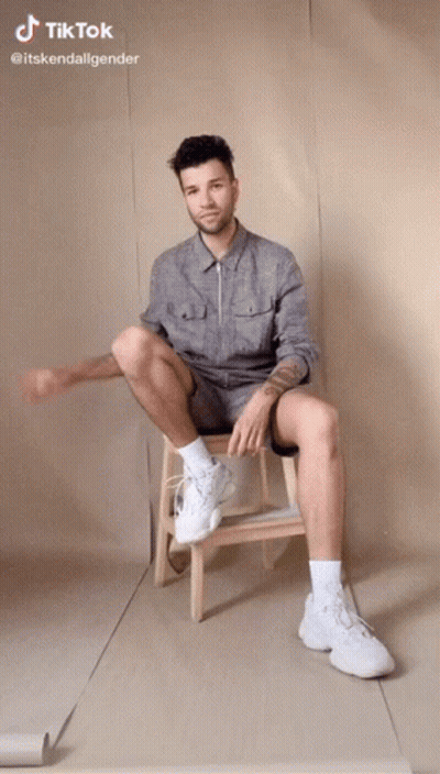 Man Sitting On Wooden Stool With Legs Crossed TikTok GIF