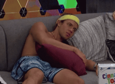 Man Sitting Shirtless With Cinnamon Pastries GIF