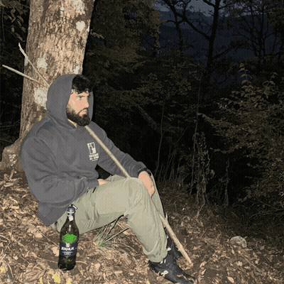 Man Sitting Under Tree With Aquafina Bottle GIF