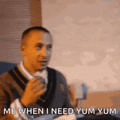 Man Sitting With Coffee Saying Yum Yum GIF