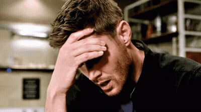 Man Sitting With Hand On Head GIF