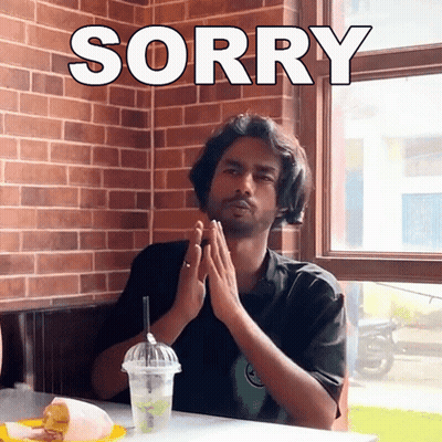 Man Sitting With Hands Folded Saying Sorry GIF
