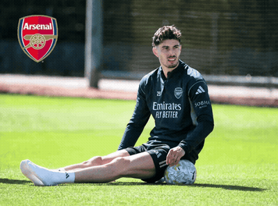 Man Sitting With Soccer Ball And Arsenal Logo GIF