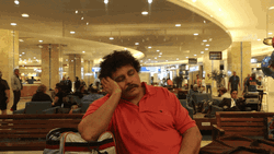 Man Sleeping At The Airport GIF