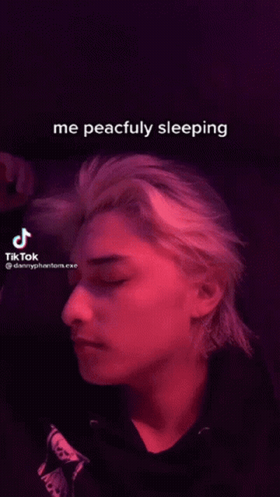 Man Sleeping In Dark Room With TikTok Video GIF