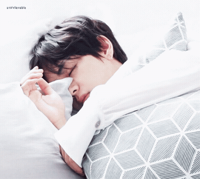 Man Sleeping On Bed With Gray And White Striped Blanket GIF