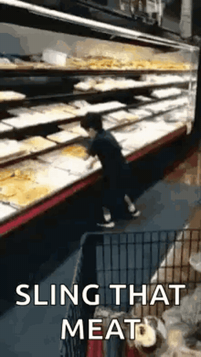 Man Slinging Meat Dog Watches In Grocery Store GIF