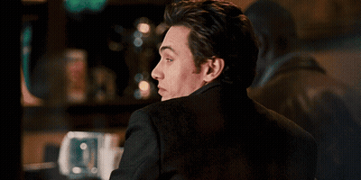 Man Smiling And Looking Over Shoulder GIF