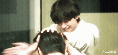 Man Smiling And Touching Another's Head GIF
